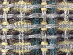 Detail of hand woven fabric in British Wool. Dye made from Goldenrod. Bradford Textile Society Design Competition